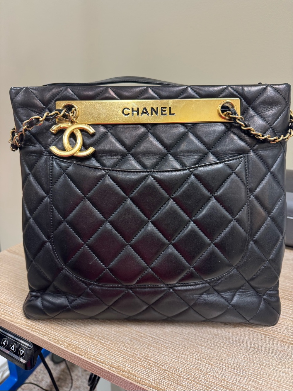 CHANEL Black Quilted Leather Shoulder Bag with Gold-Tone Plate and CC Charm